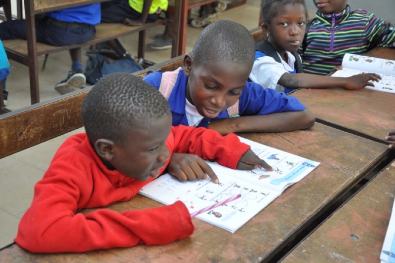 The Gambia - Students sharing a textbook in class
